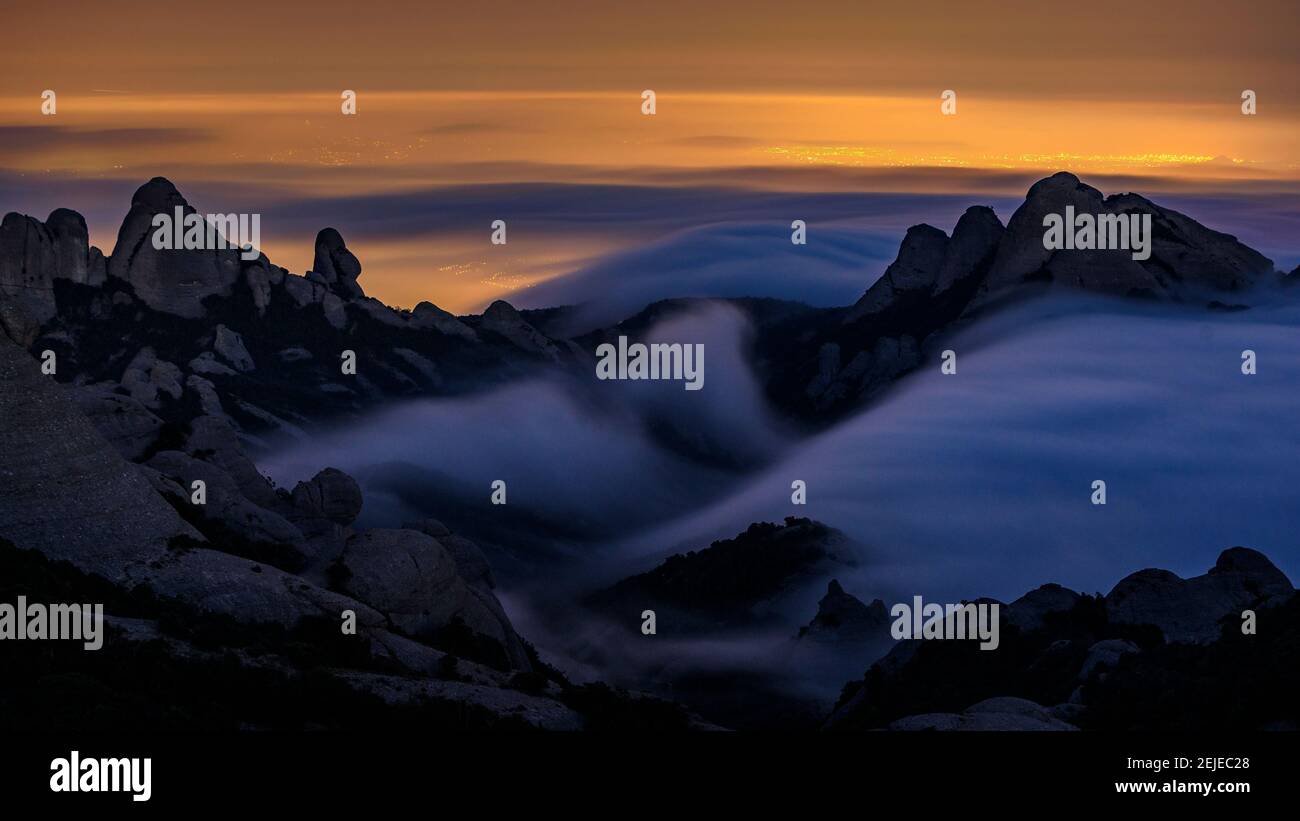 Night in Montserrat with fog, seen from the Sant Jeroni summit (Barcelona region, Catalonia, Spain) Stock Photo