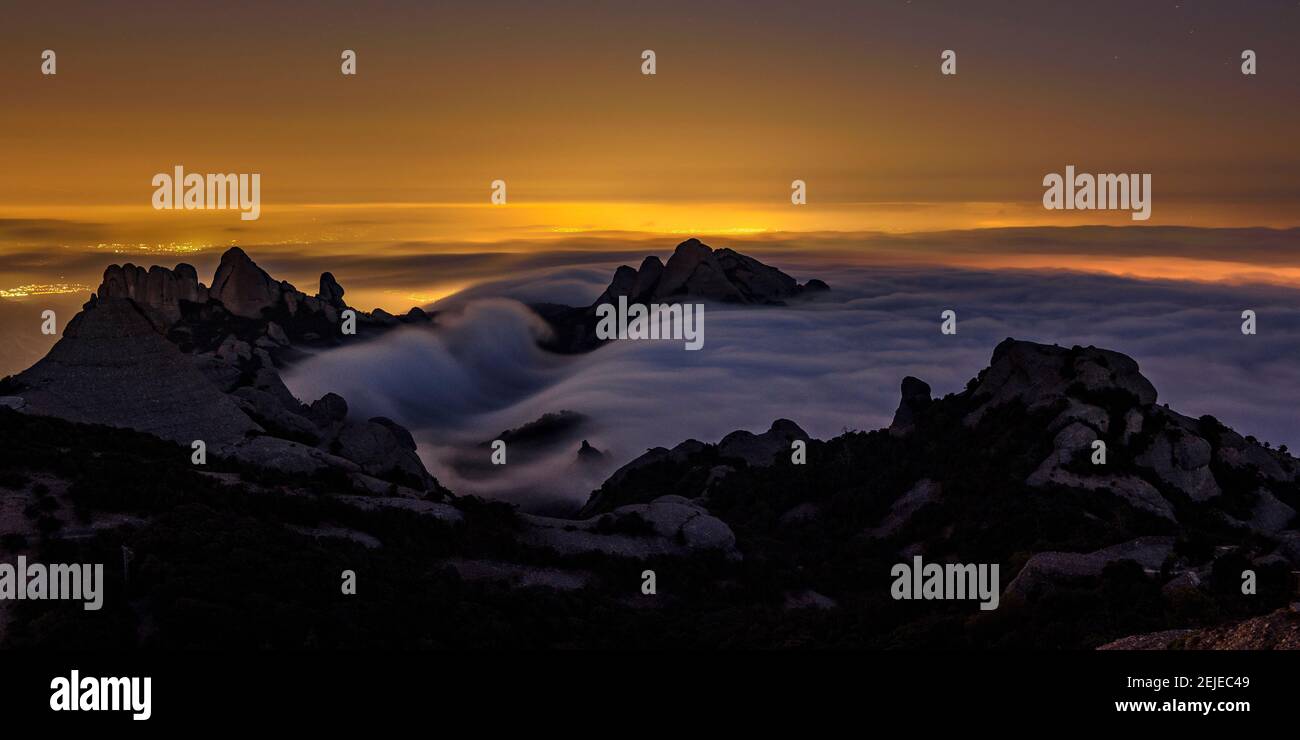 Night in Montserrat with fog, seen from the Sant Jeroni summit (Barcelona region, Catalonia, Spain) Stock Photo