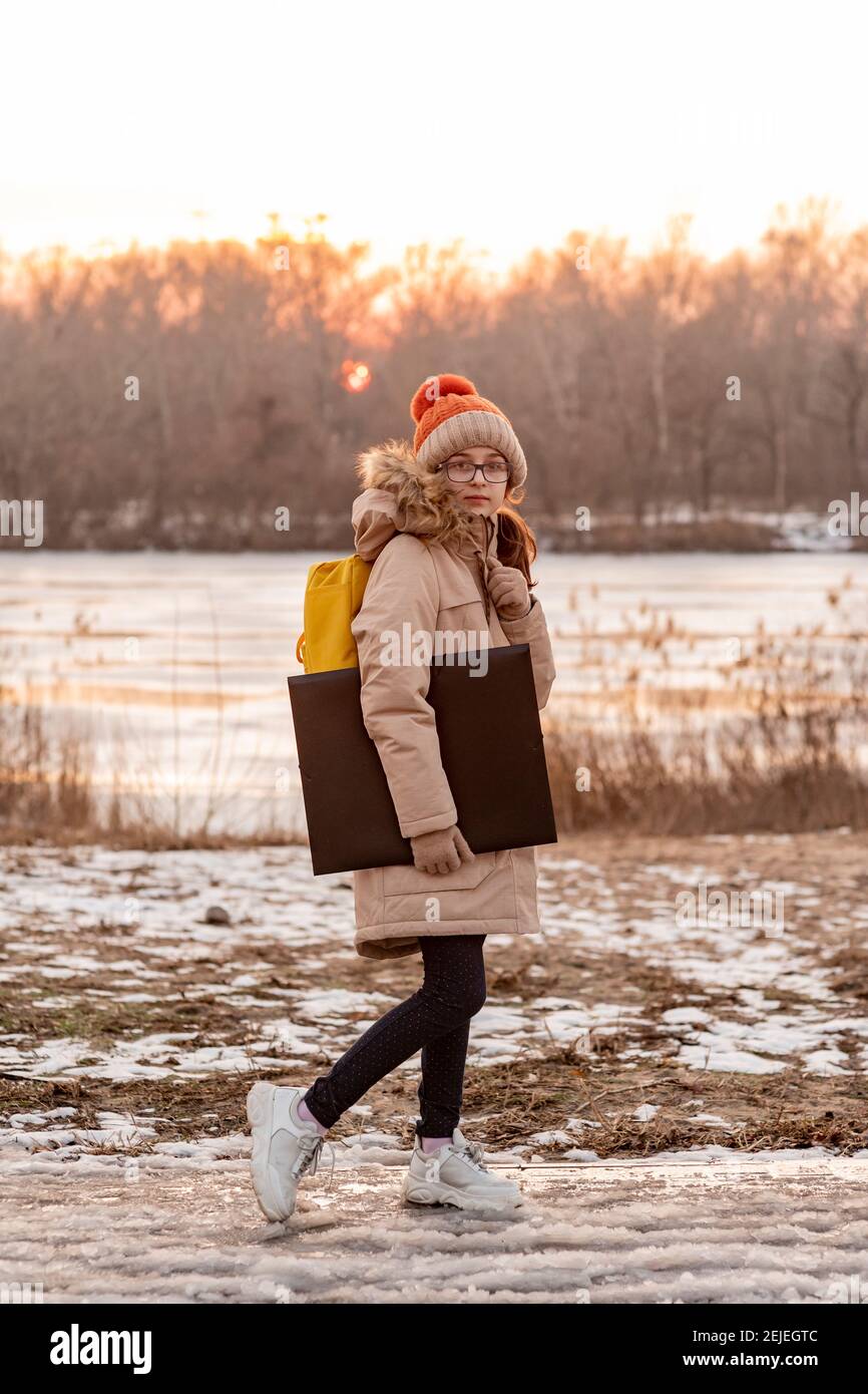 Portrait of teenager girl with school backpack holding folders. girl ...