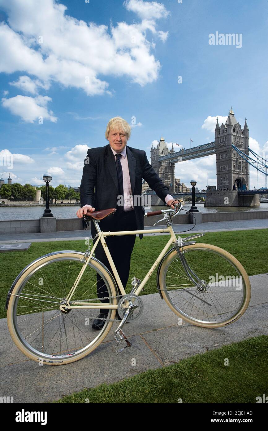 Great Britain /London / Boris Johnson mayor of London standing with bicycle in front of Tower Bridge . Stock Photo