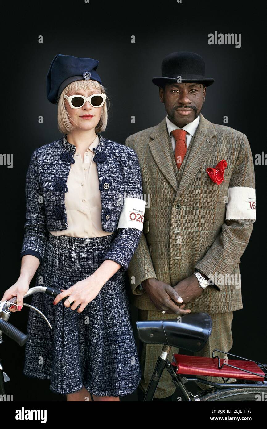 GREAT BRITAIN / London/ couple with Caucasian woman and black male posing with bicycle and vintage clothes . Stock Photo