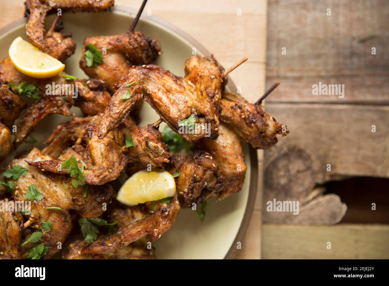 British chicken wings that have been marinated in chilli spices and zatar seasoning before being skewered on bamboo kebab skewers and then grilled. En Stock Photo