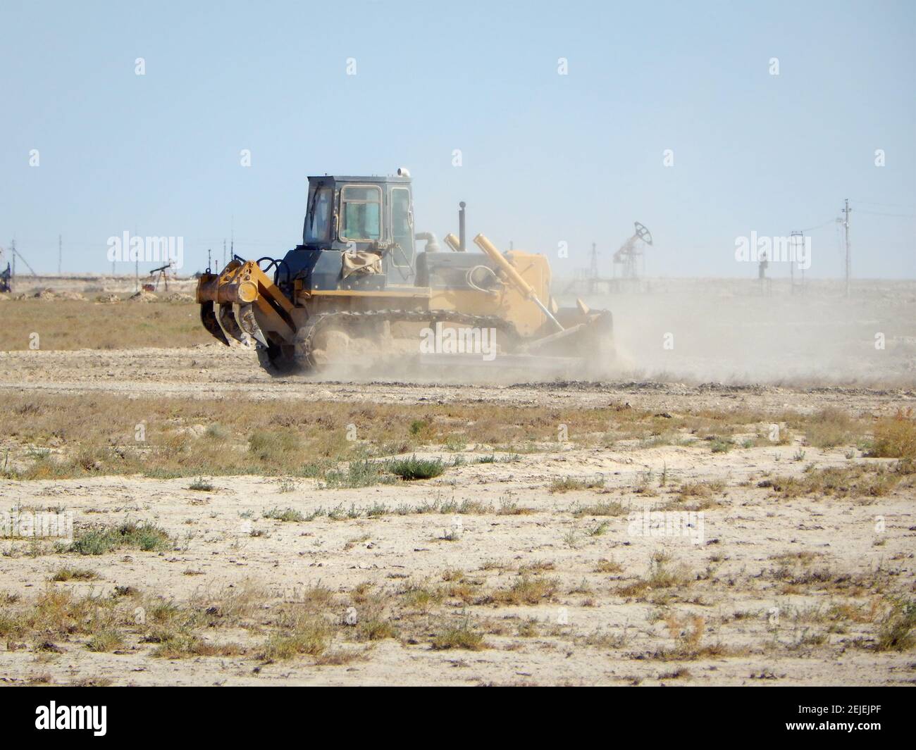 Bulldozer in the steppes level the site. Kazakhstan. Oil field. Mangistau region. August 17, 2019 year. Stock Photo