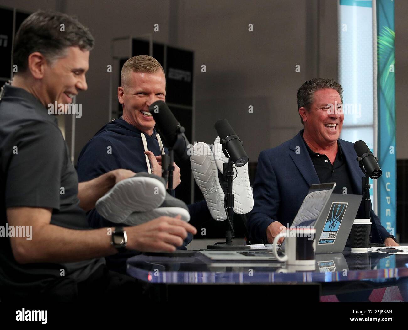 Dan Marino hands out Isotoner Slip-Ons as he is interviewed by Chris Simms  on NBC Sports Radio/NBCSN program ProFootballTalk Live. He is a  spokesperson for the company and was promoting the product.