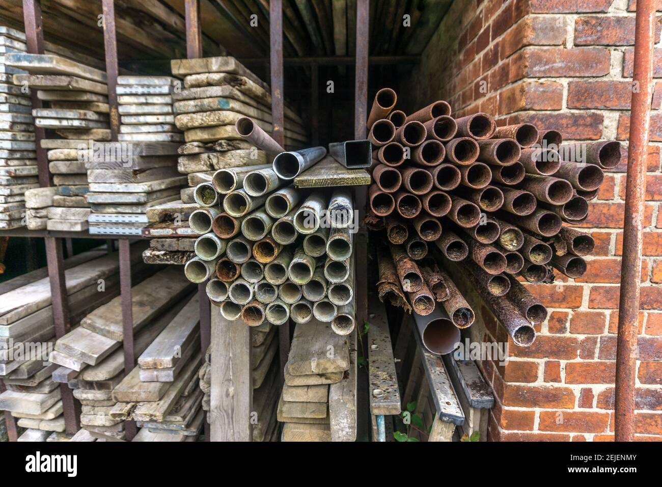 Scaffolding, poles and planks in storage Stock Photo