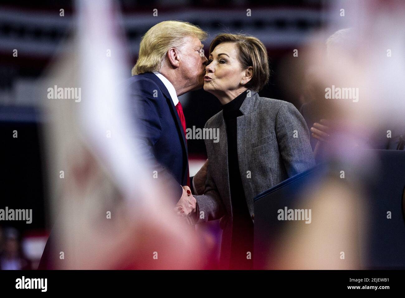 Jan 30, 2020; Des Moines, IA, USA; Iowa governor Kim Reynolds kisses the  cheek of President Donald Trump after he called her up on stage during a  campaign rally on Thursday, Jan.