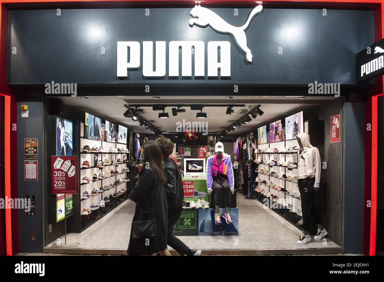 Pedestrians walk past by a Puma, German multinational sportswear brand,  shop in Hong Kong. (Photo by Budrul Chukrut / SOPA Images/Sipa USA Stock  Photo - Alamy