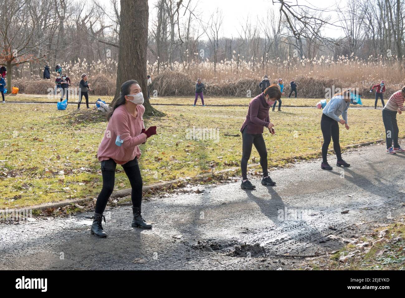 On a cold winter morning, Asian American women, primarily Chinese, attend a dance exercise class in a park in Flushing, Queens, New York City. Stock Photo