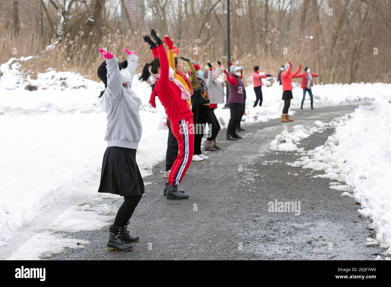 On a winter morning, Asian American women, primarily Chinese, attend a dance exercise class in a park in Flushing, Queens, New York City. Stock Photo