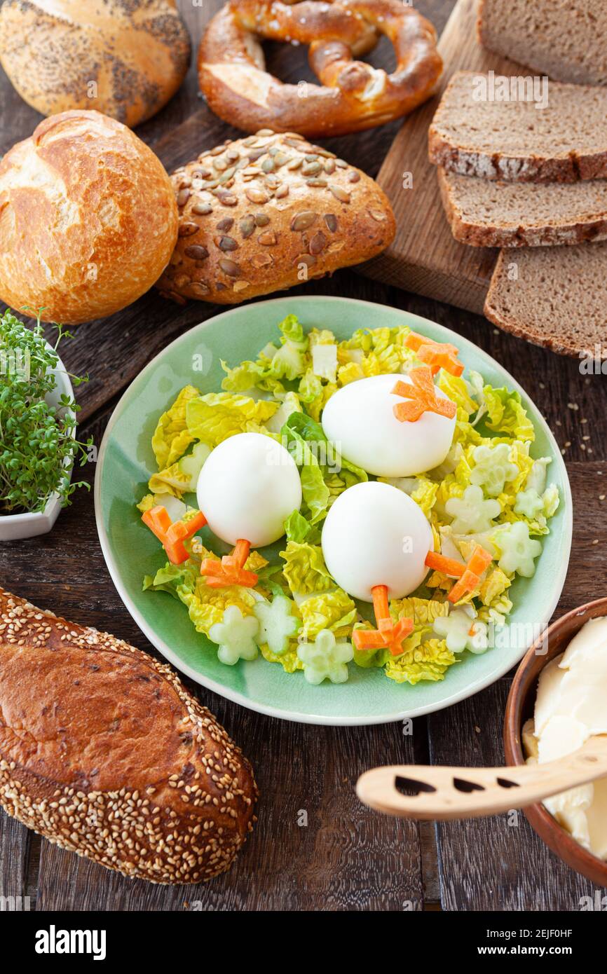 Easter breakfast with hard boiled eggs and bread rolls Stock Photo