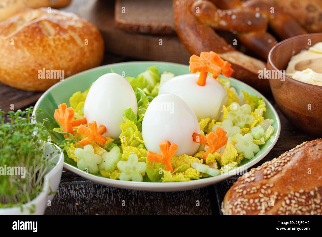 Easter breakfast with hard boiled eggs and bread rolls Stock Photo