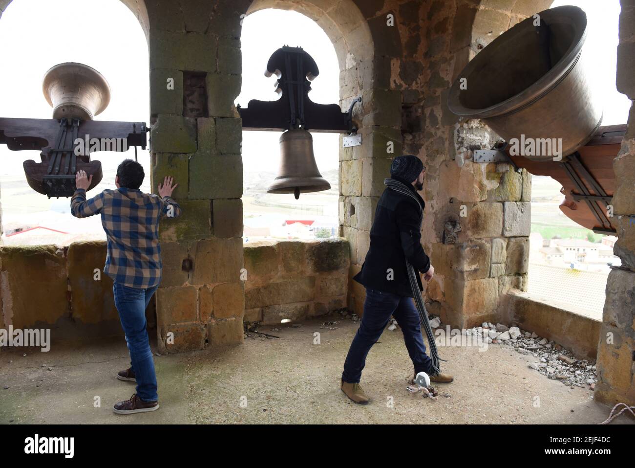 Men ring bells inside a church tower during the protest in Gómara