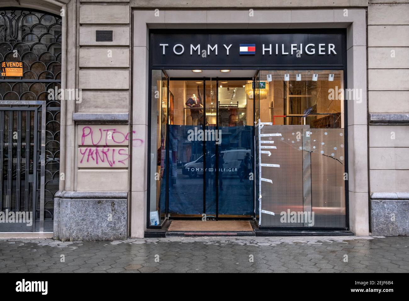 Barcelona, Spain. 22nd Feb, The Tommy Hilfiger store on Passeig de Gràcia is seen with anti-vandalism protections its windows.More than 50 stores have suffered damage to their shop windows and