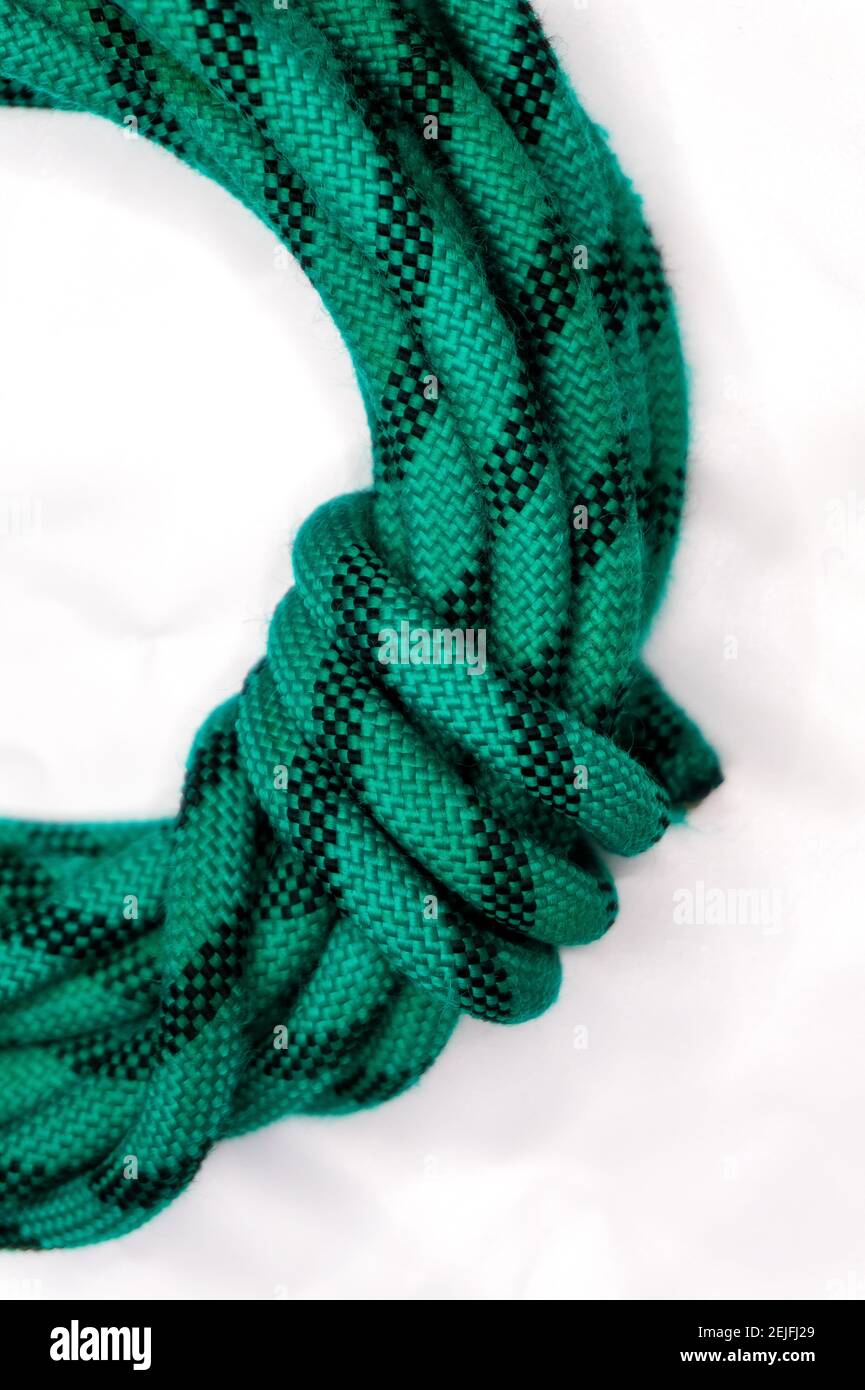 green climbing rope folded with a knot on white background Stock Photo ...
