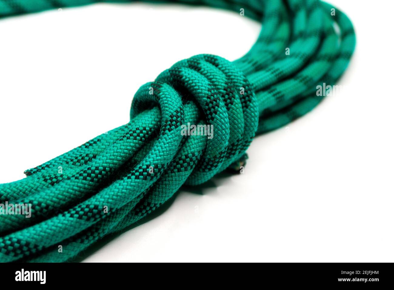 green climbing rope folded with a knot on white background Stock Photo ...