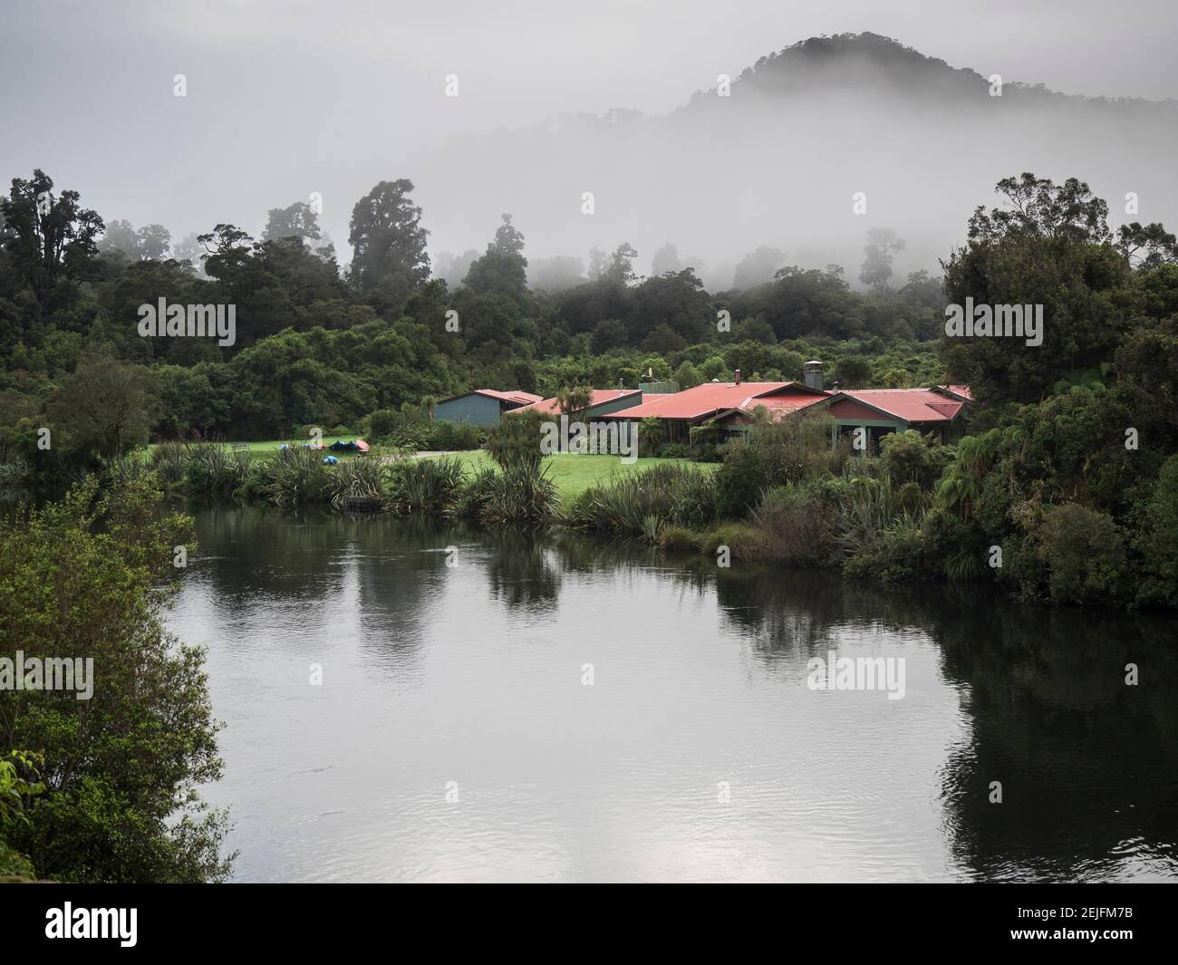 Cottage in park at lakeshore, Te Wahipounamu, Lake Moeraki, West Coast, South Island, New Zealand Stock Photo