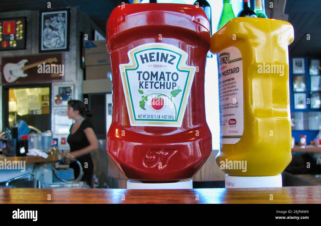 Heinz ketchup and mustards bottles on the counter of a restaurant. Stock Photo