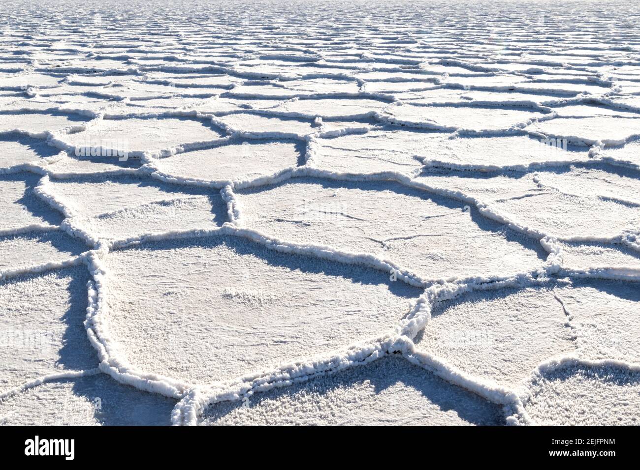 Salt deposits, Badwater Basin, Death Valley, California. Geometric formations snake into the distance, with the floor covered with patches of crystals. Stock Photo
