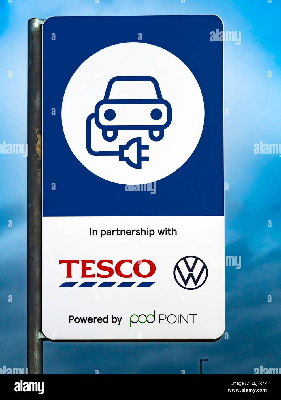 Sign for Pod Point charging point for an electric vehicle  a co-venture between Tesco and Volkswagen in a shopping car park in Redcar North Yorkshire Stock Photo