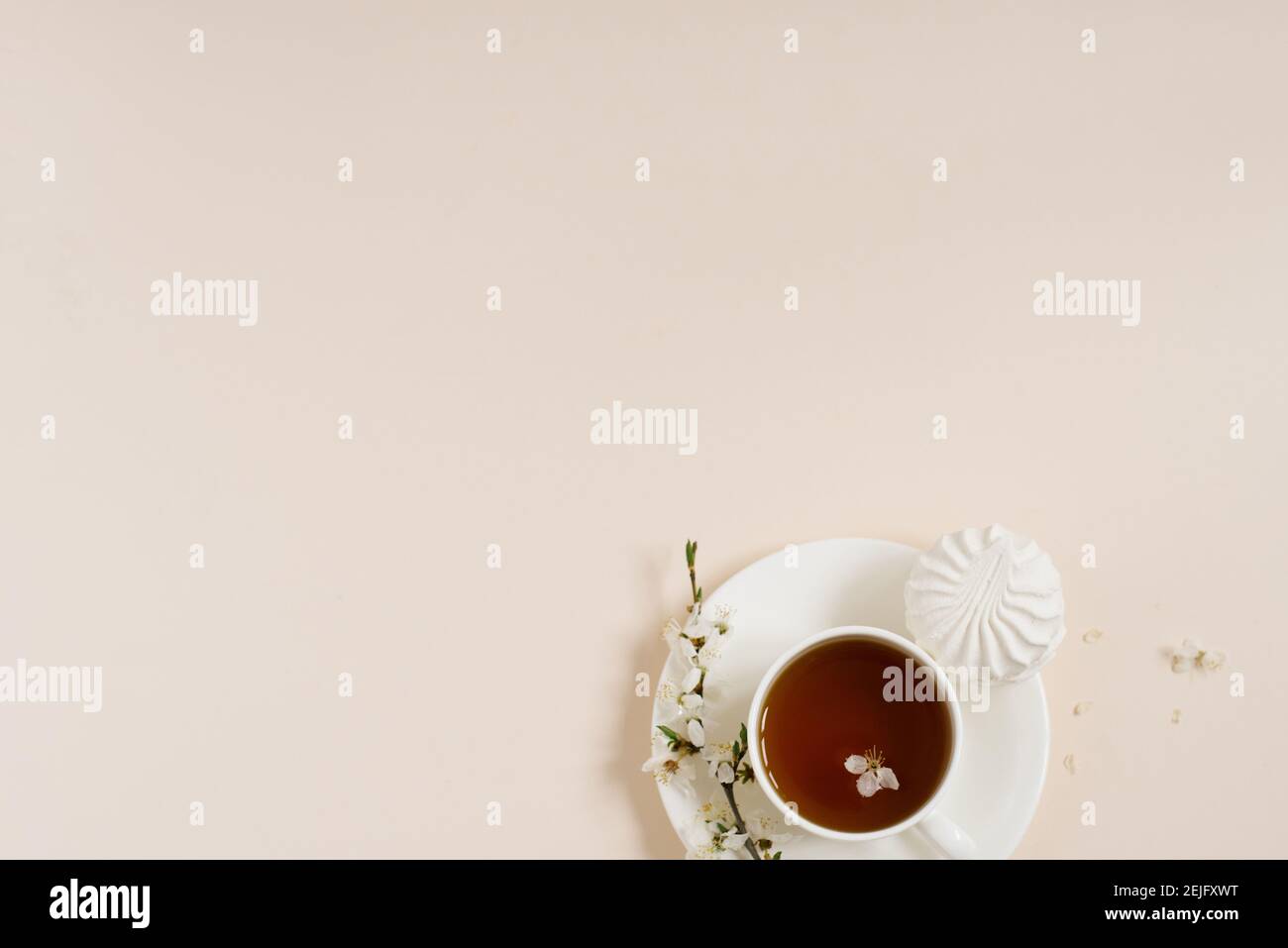 Spring concept. Cup of morning black tea with sweets marshmallows on ...