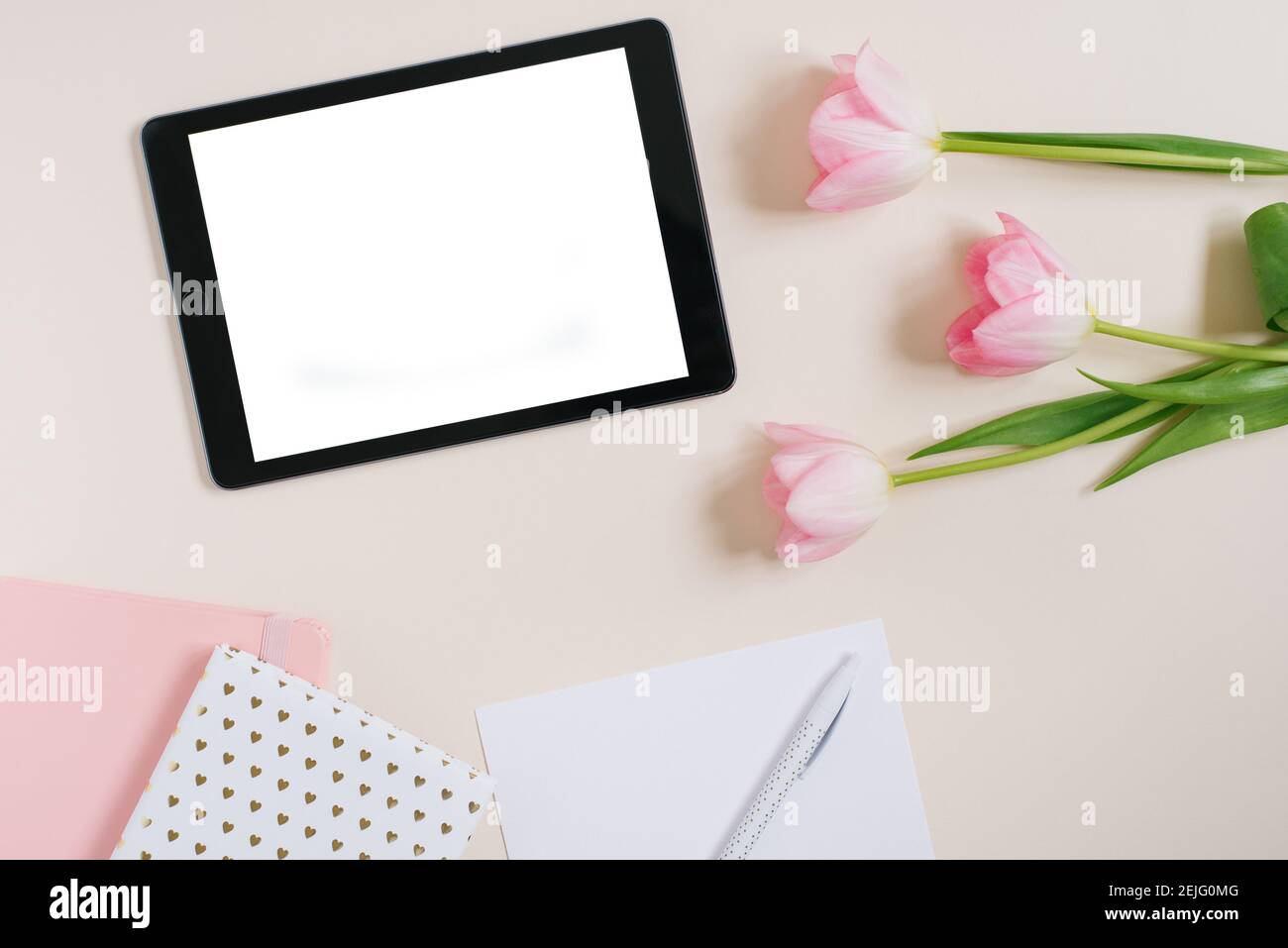 Spring background flat lay of pink tulips with tablet mockup, copy ...