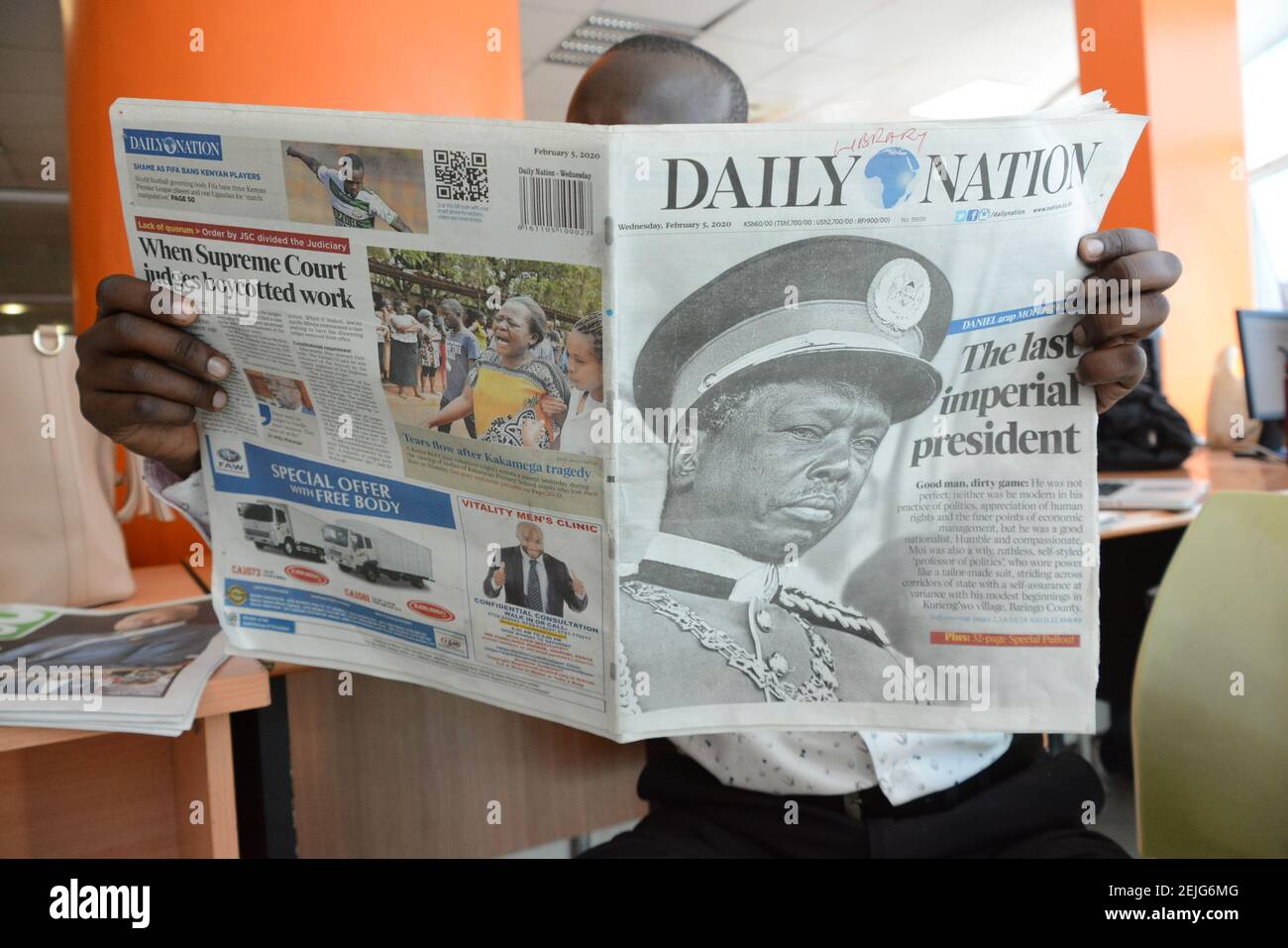 A man reads a copy of The Daily Nation newspaper that reports the death of  Daniel Arap Moi. Former President of Kenya, Daniel Arap Moi died aged 95  while undergoing treatment at