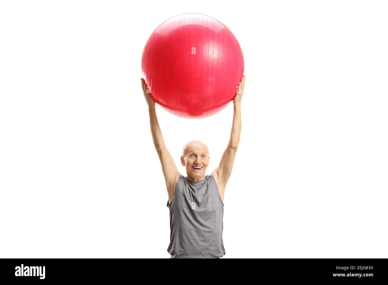 Elderly man exercising with a ball isolated on white background Stock Photo