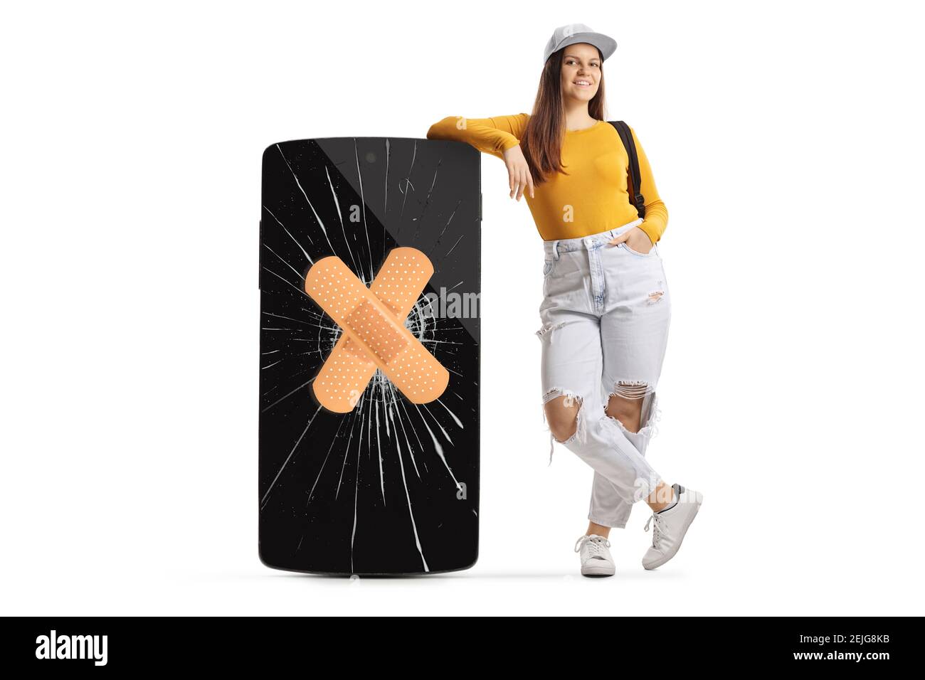 Full length portrait of a female leaning on a big mobile phone with a broken screen and band aid isolated on white background Stock Photo