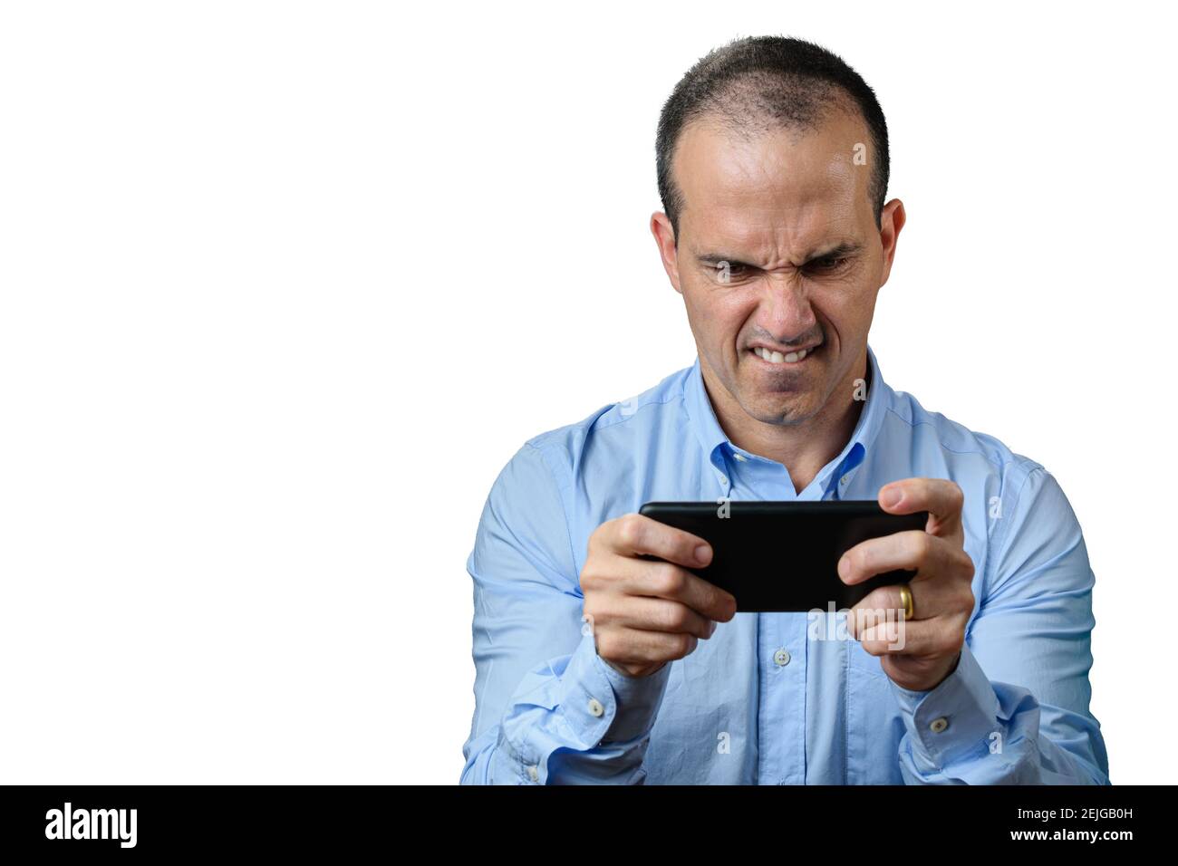 Mature man in formal wear playing on his smartphone and biting his lower lip. Stock Photo