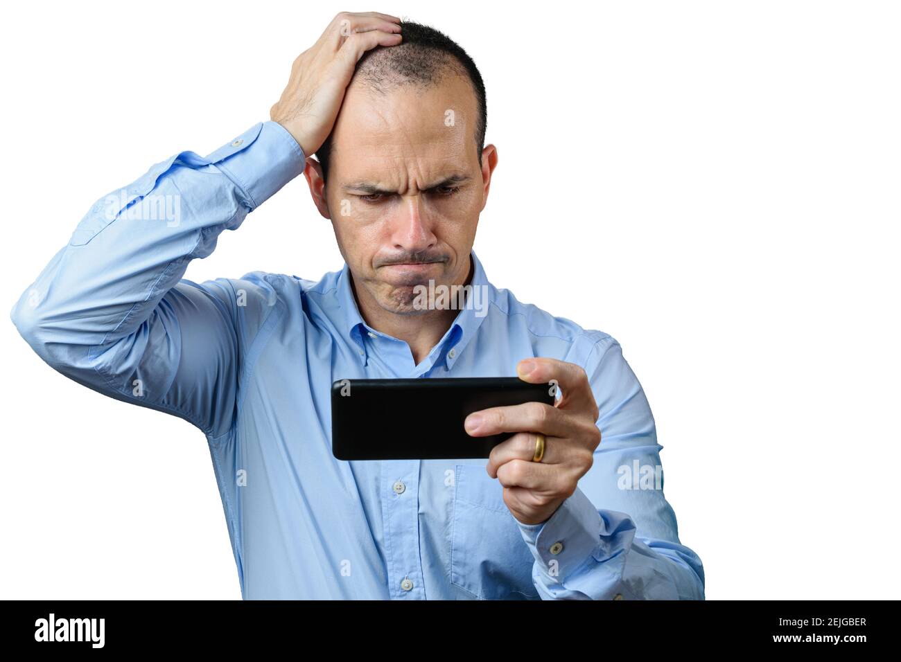 Mature man in formal wear, looking at his smartphone, disappointed and with his right hand on his head. Stock Photo