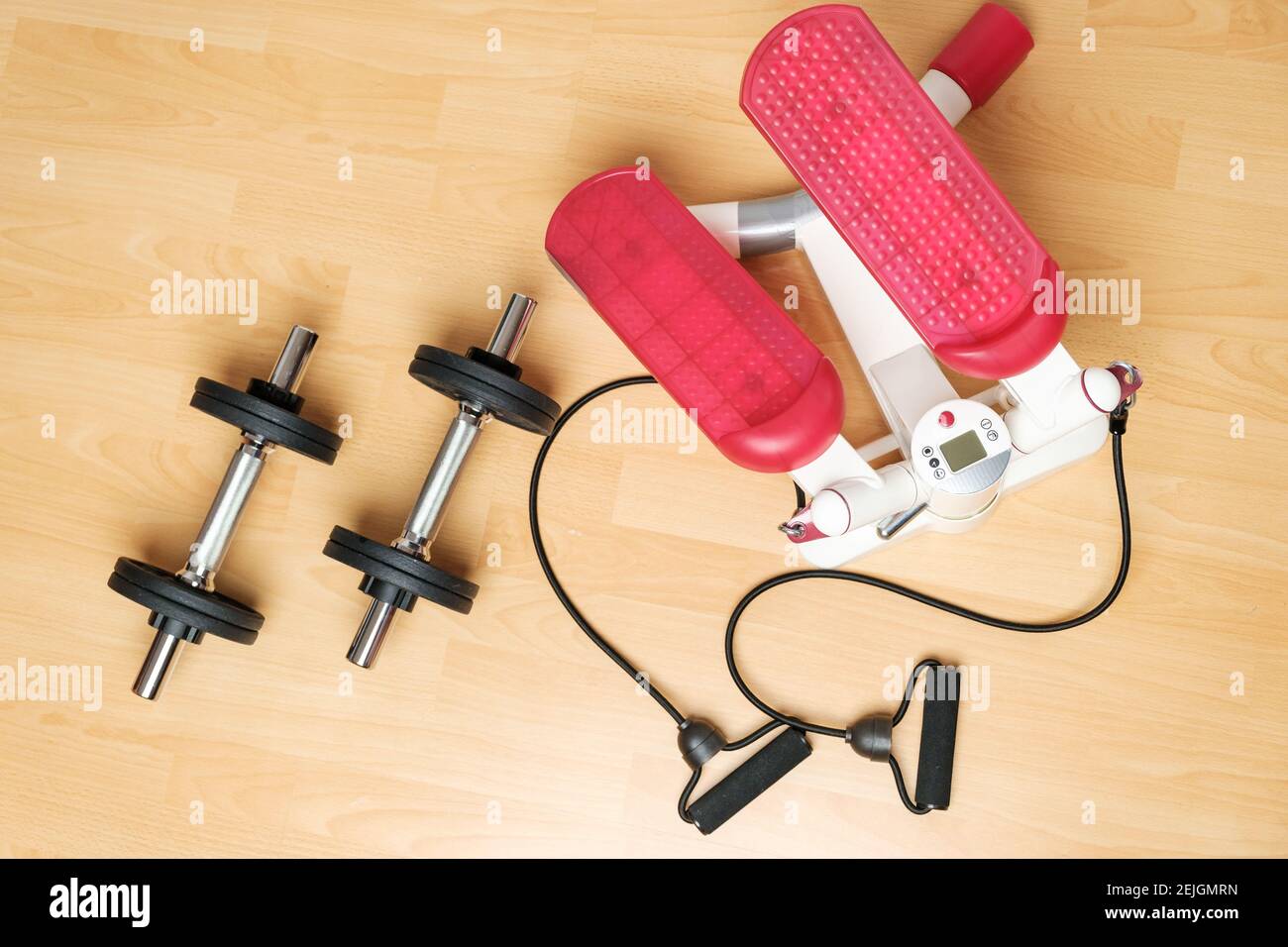 Dumbbells and twister stepper on the floor at home. Keeping fit during lockdown. Fitness equipment for strength training  Stock Photo