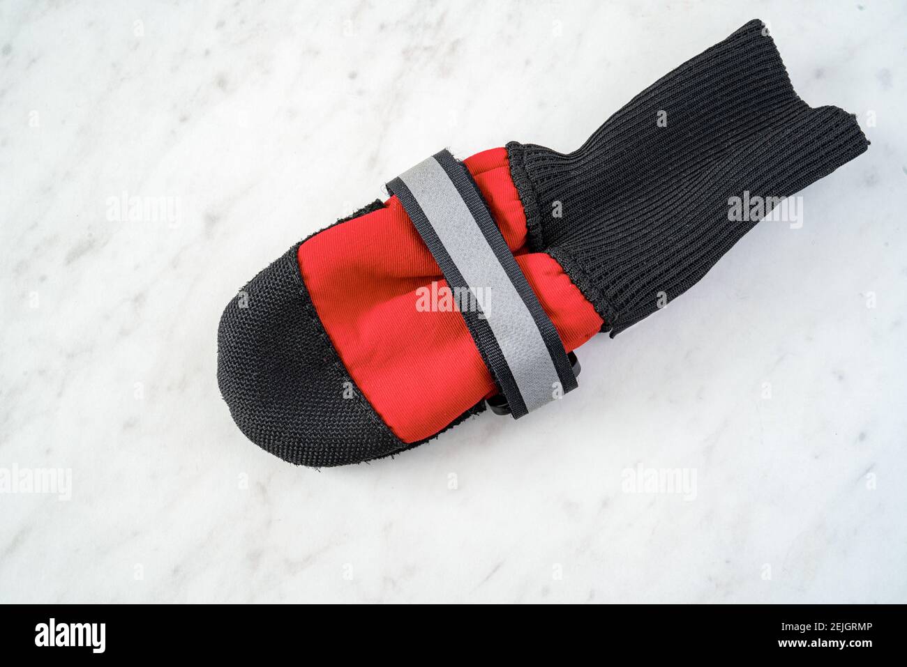 Dog boots on a white marble background. Stock Photo