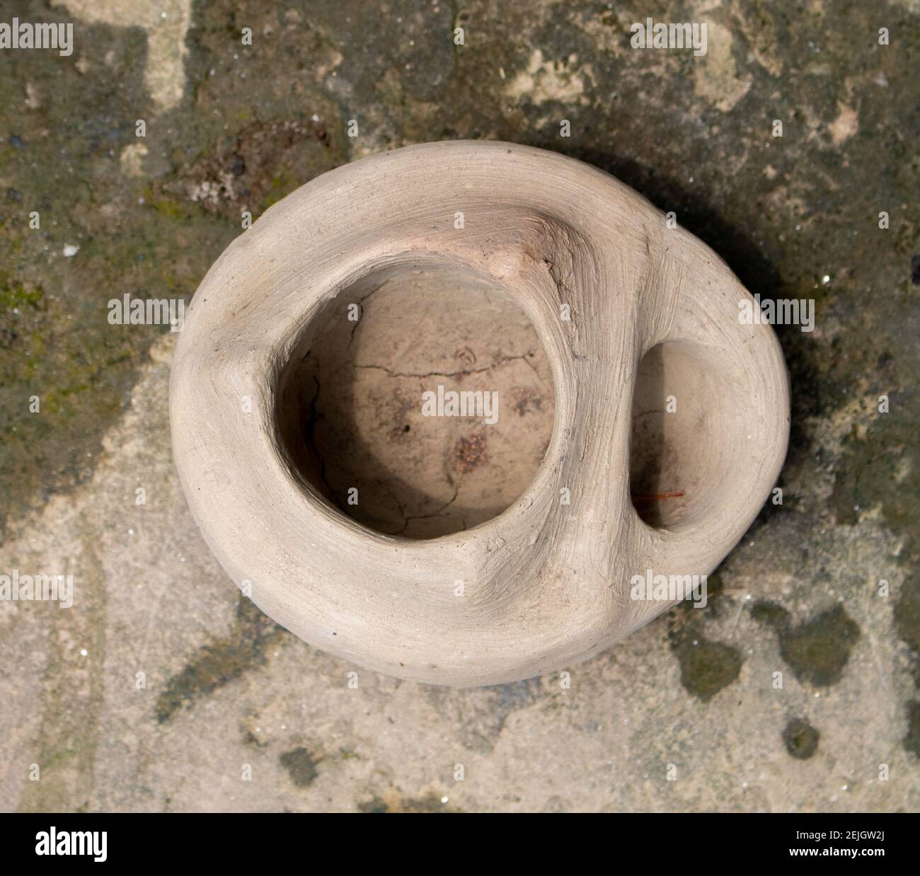 This is a handmade Bangladeshi clay stove. It is used for cooking in