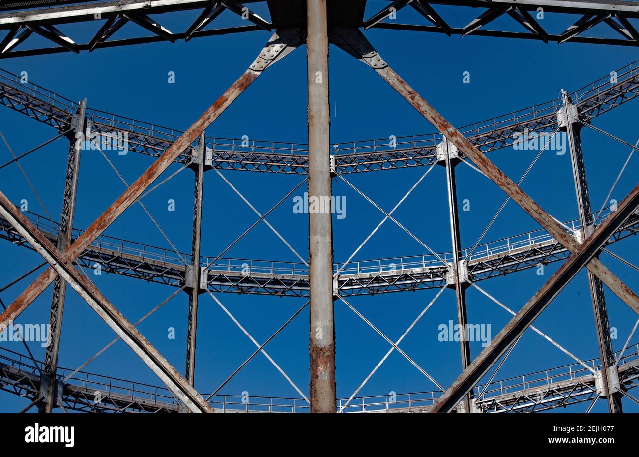 Berlin, Germany. 22nd Feb, 2021. View through struts of the gasometer to blue sky. The participation procedure for the conversion of the listed Gasometer ends on 24 February. If the owner has his way, the over 100-year-old steel construction is to be given a new lease of life as the shell of an office building. However, a citizens' initiative wants to prevent this and is calling for signatures on a petition. Credit: Paul Zinken/dpa-Zentralbild/ZB/dpa/Alamy Live News Stock Photo