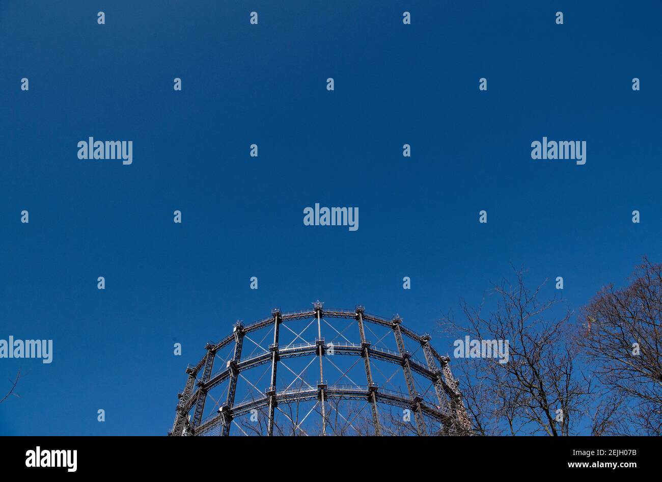 Berlin, Germany. 22nd Feb, 2021. View through struts of the gasometer to blue sky. The participation procedure for the conversion of the listed Gasometer ends on 24 February. If the owner has his way, the over 100-year-old steel construction is to be given a new lease of life as the shell of an office building. However, a citizens' initiative wants to prevent this and is calling for signatures on a petition. Credit: Paul Zinken/dpa-Zentralbild/ZB/dpa/Alamy Live News Stock Photo