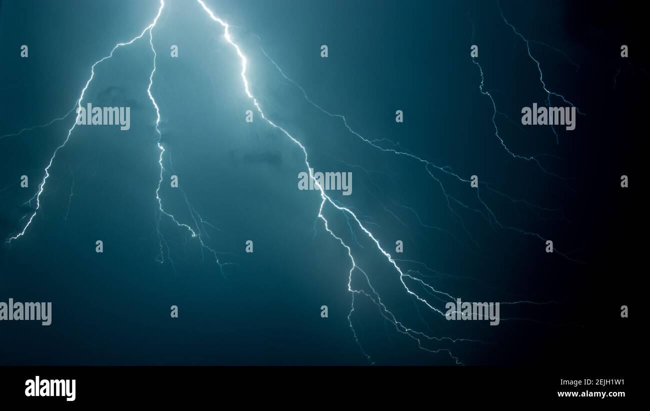 Low angle shot of the scary lightning in the night sky Stock Photo - Alamy