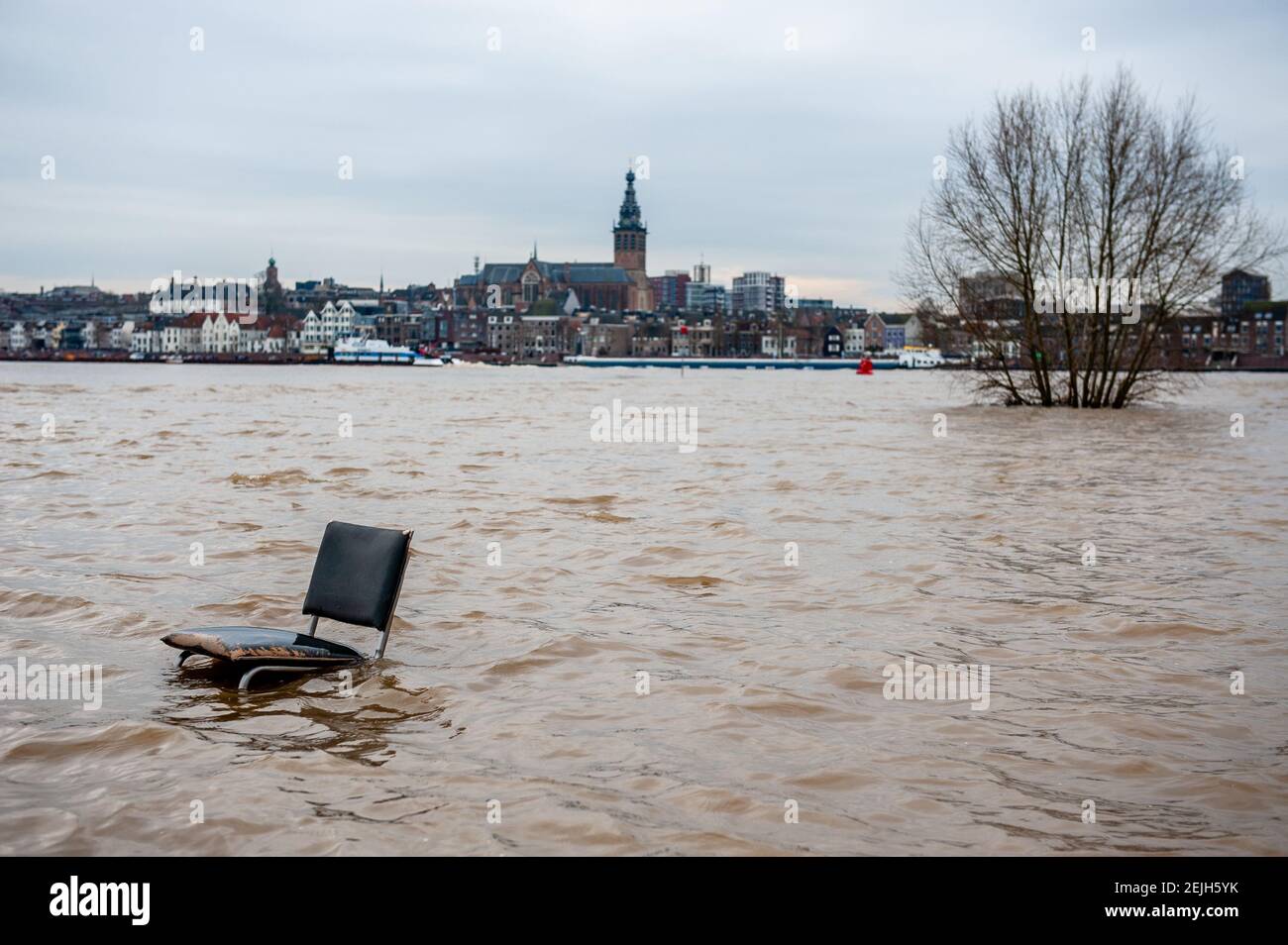 A chair floating on the water. Flood plains along the banks of the