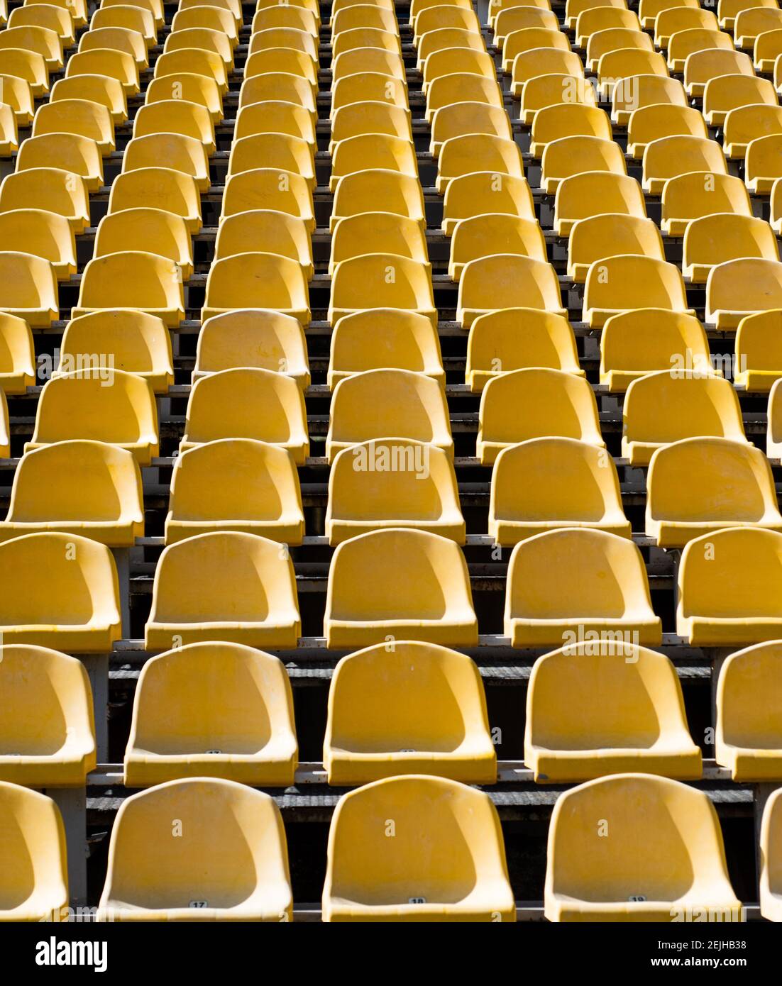 empty seats. modern stadium. yellow tribunes. seats of tribune on sport  stadium. empty outdoor arena. concept of fans. chairs for audience.  cultural environment concept. color and symmetry Stock Photo - Alamy
