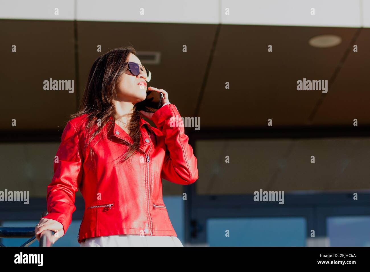 Hispanic woman talking on the phone outdoors Stock Photo
