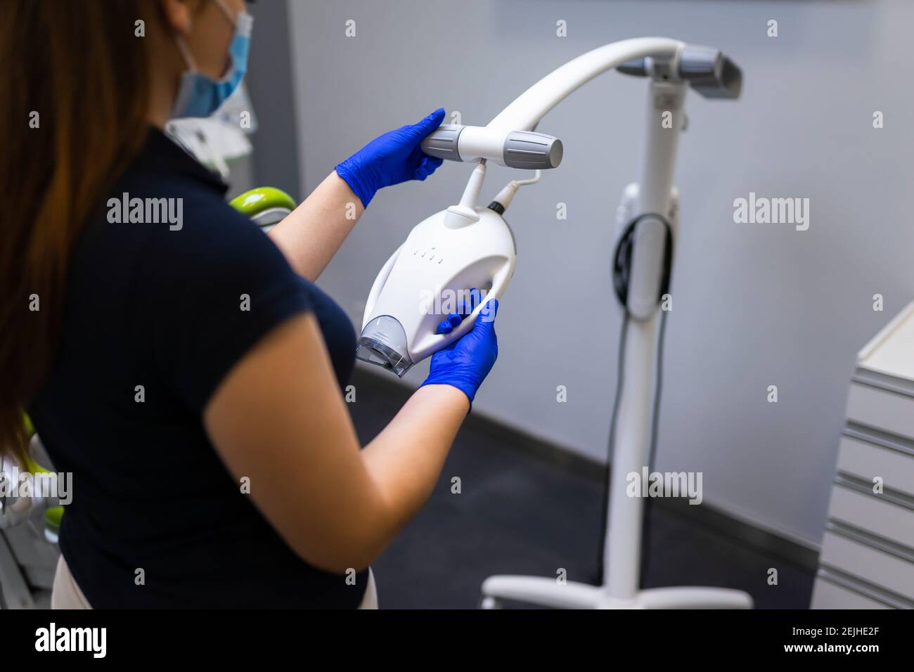 Dentist with teeth whitening machine Stock Photo - Alamy