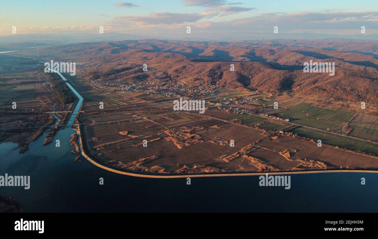 Aerial view of a river flowing through a village Stock Photo - Alamy