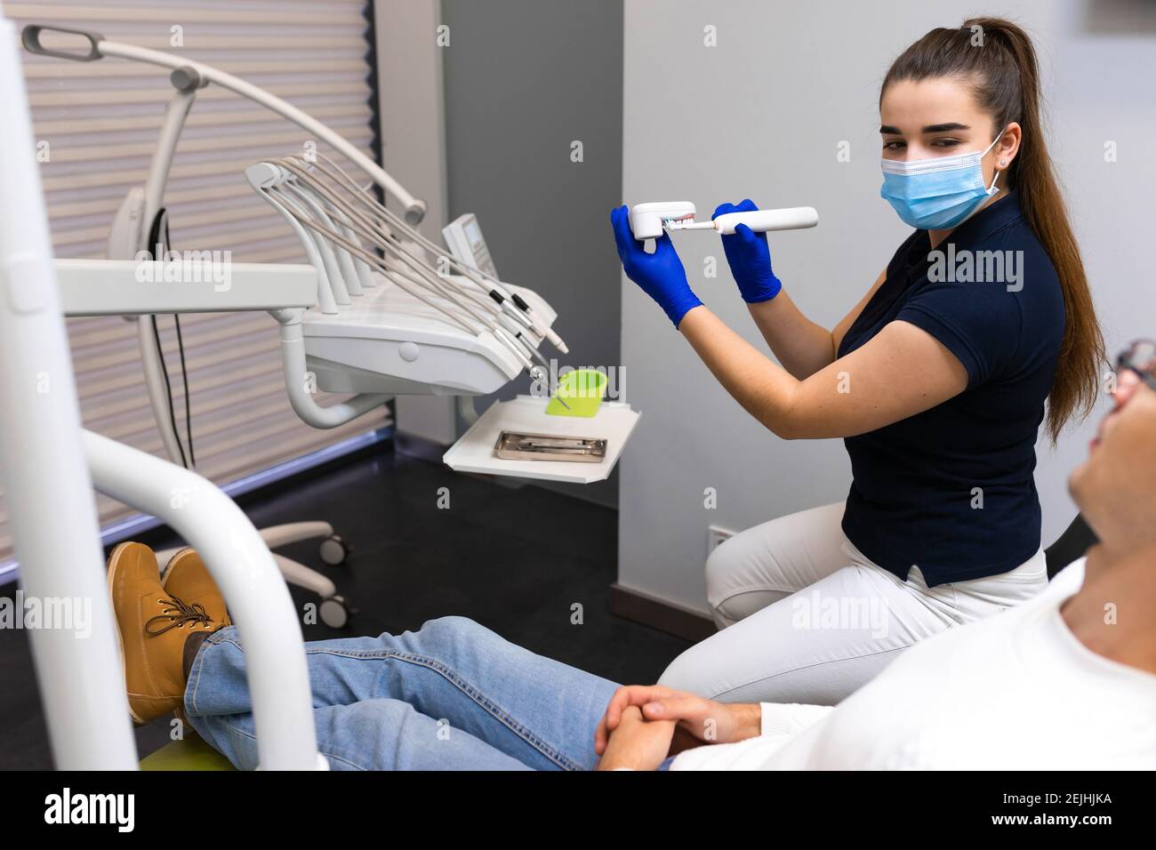 Dentist teaches patient how to clean teeth. Dental hygiene concept