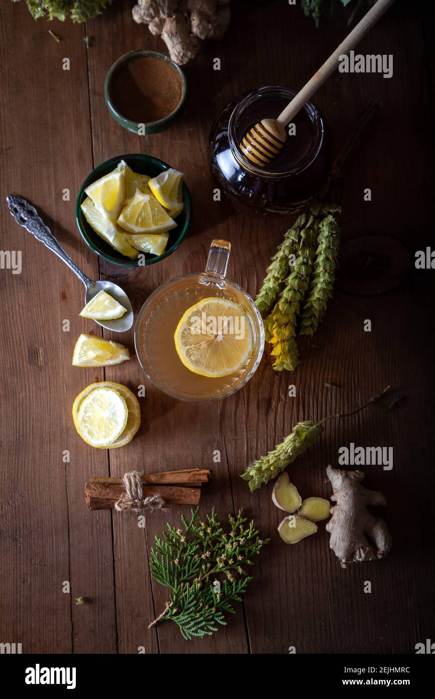 Dried mountain tea, turmeric, cinnamon sticks, lemon slices and jar of honey on wooden background.  Sideritis Scardica. Stock Photo