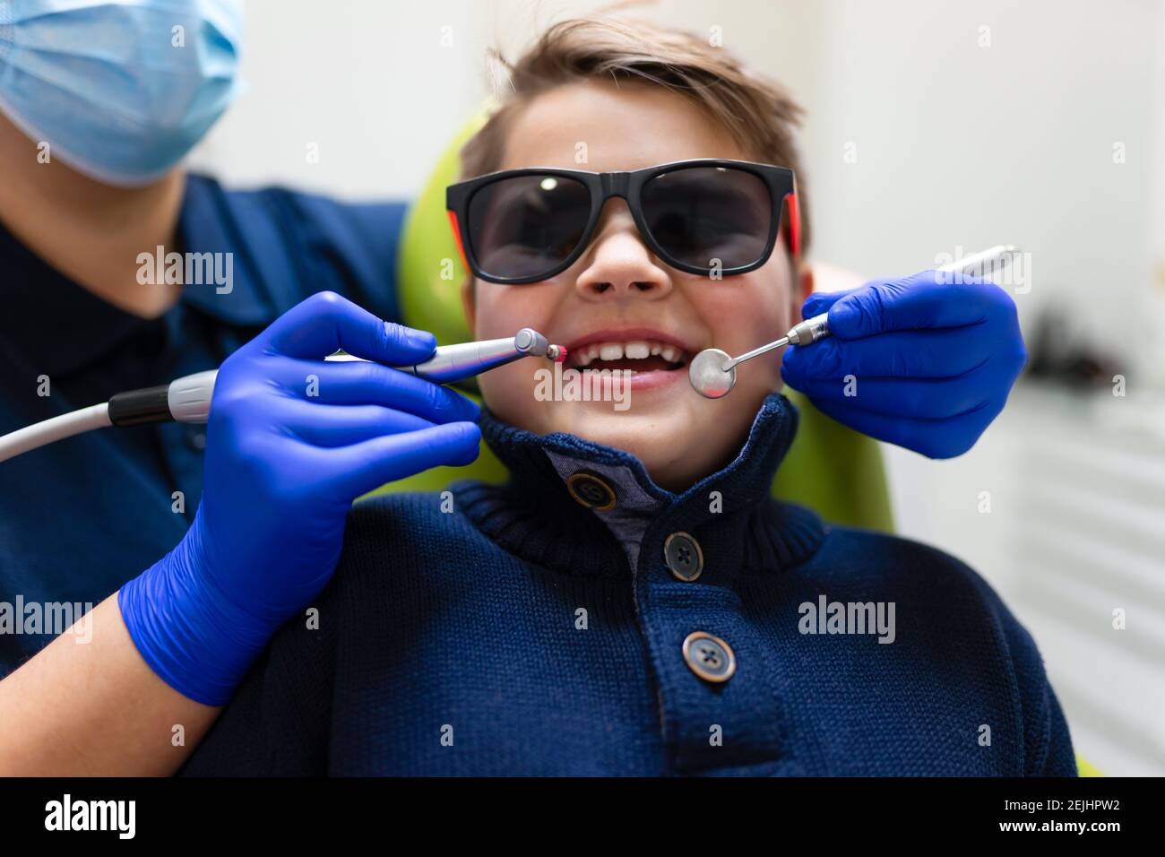 Woman dentist make preventive dental plaque cleaning for teenager Stock