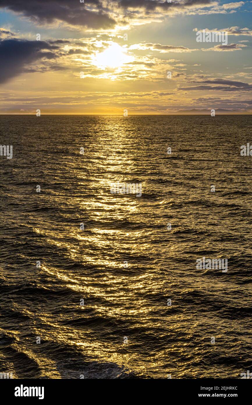 A sunset over the NW Pacific coast near Prince of Wales Island, Alaska, USA - Viewed from a cruise ship sailing the Inside Passage Stock Photo