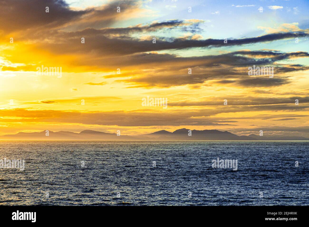 A sunset over the NW Pacific coast near Prince of Wales Island, Alaska, USA - Viewed from a cruise ship sailing the Inside Passage Stock Photo