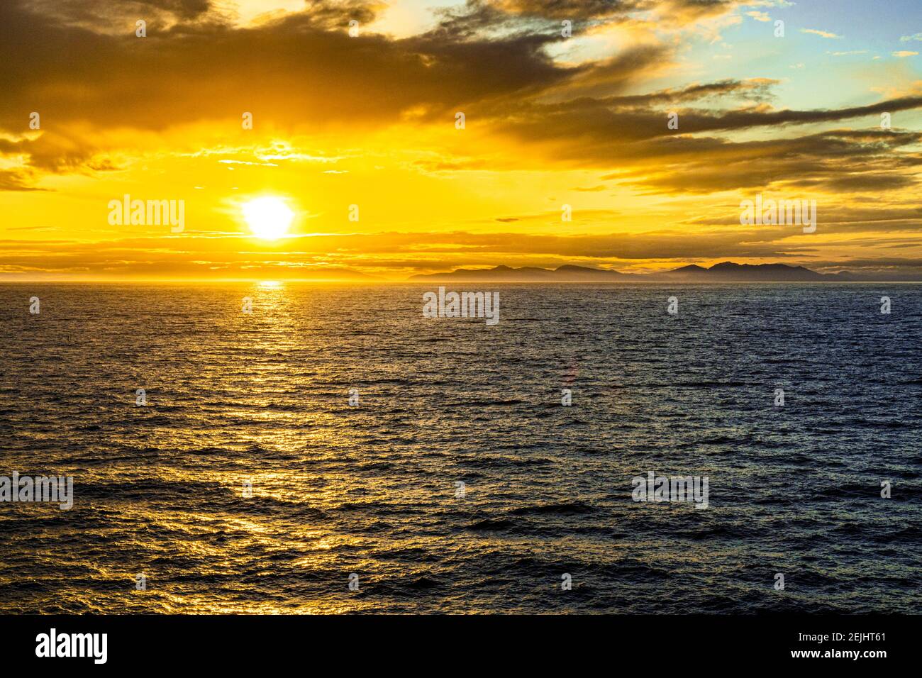 A sunset over the NW Pacific coast near Prince of Wales Island, Alaska, USA - Viewed from a cruise ship sailing the Inside Passage Stock Photo