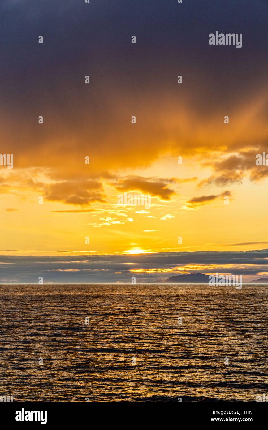 A sunset over the NW Pacific coast near Prince of Wales Island, Alaska, USA - Viewed from a cruise ship sailing the Inside Passage Stock Photo