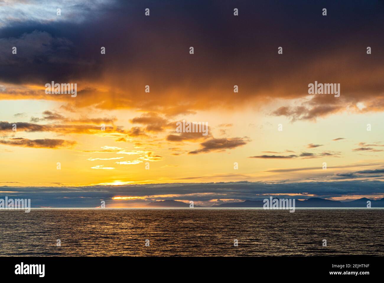 A sunset over the NW Pacific coast near Prince of Wales Island, Alaska, USA - Viewed from a cruise ship sailing the Inside Passage Stock Photo