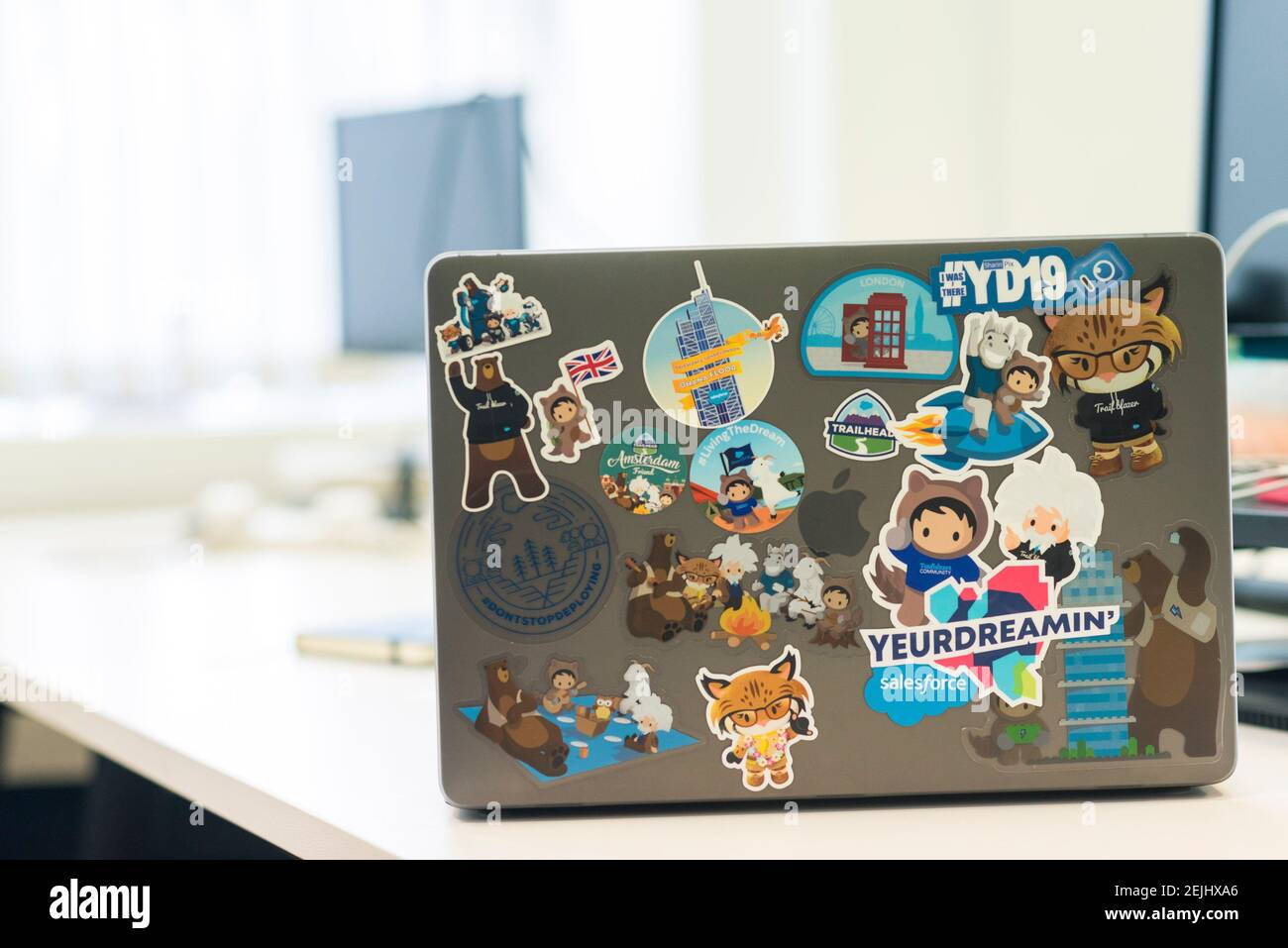a personalised mac book lap top with stickers on the outside Stock Photo